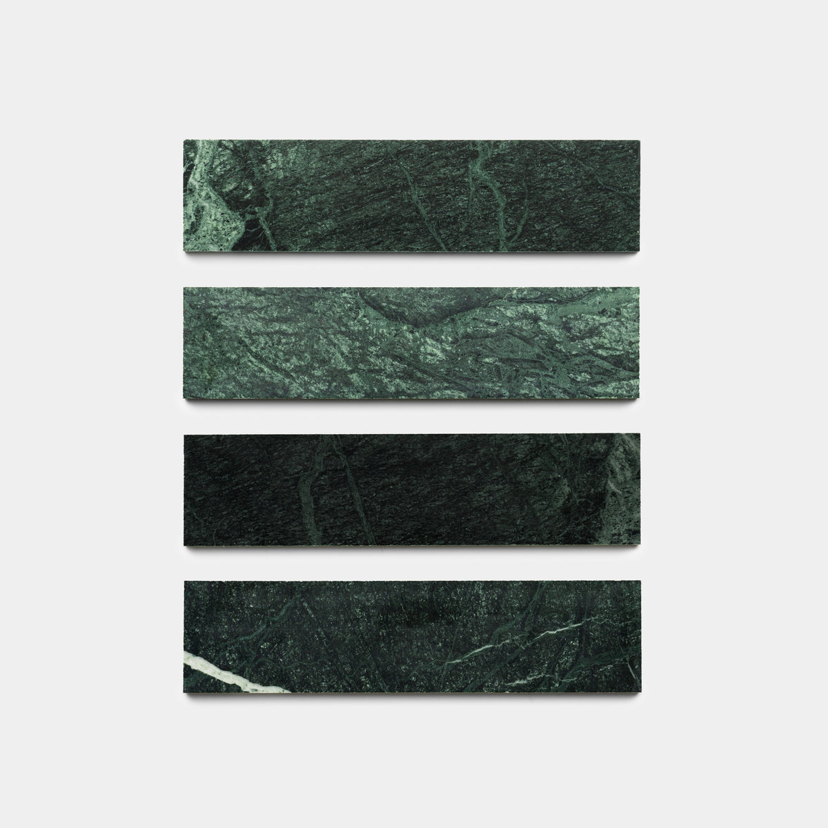 Four Verde Alpi 3x12 rectangular tiles by Zia Tile are arranged in a vertical column on a plain white background, evenly spaced apart.