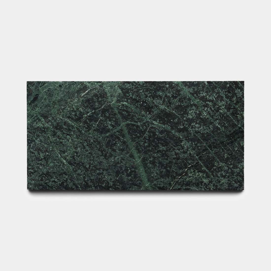 The Zia Tile Verde Alpi 6x12 is a rectangular, dark green marble tile with lighter green veining and textured patterns, shown on a plain white background—an elegant piece showcasing signature craftsmanship.