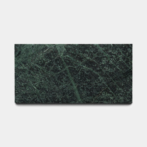 The Zia Tile Verde Alpi 6x12 is a rectangular, dark green marble tile with lighter green veining and textured patterns, shown on a plain white background—an elegant piece showcasing signature craftsmanship.