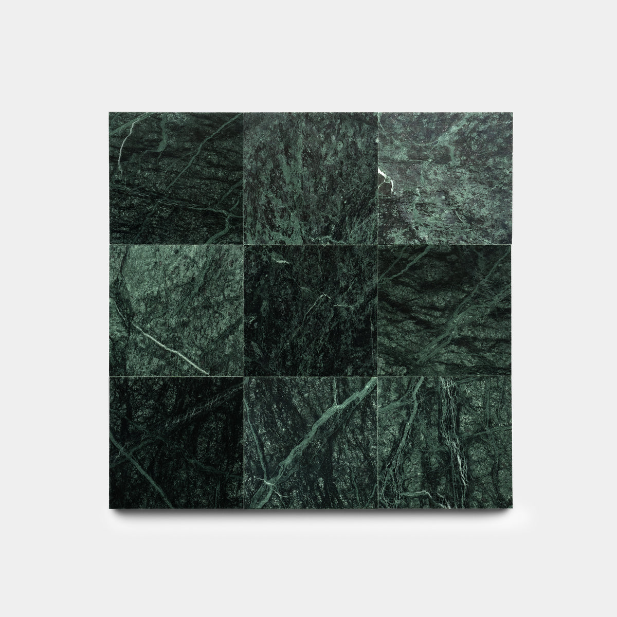 A square set of nine Verde Alpi 6x6 sample tiles from Zia Tile, featuring dark green marble with natural lighter green and white veining, is displayed on a plain light gray background.