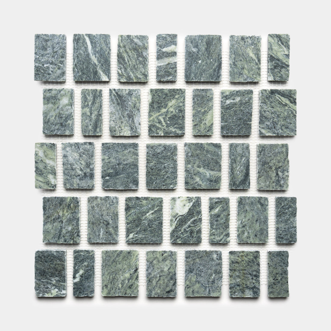 Scarpa in Verde Alpi by Zia Tile showcases square, gray-green stone tiles with white veining and a rough, natural texture. Set against a white background, each tile is separated by small, even gaps for a refined look.