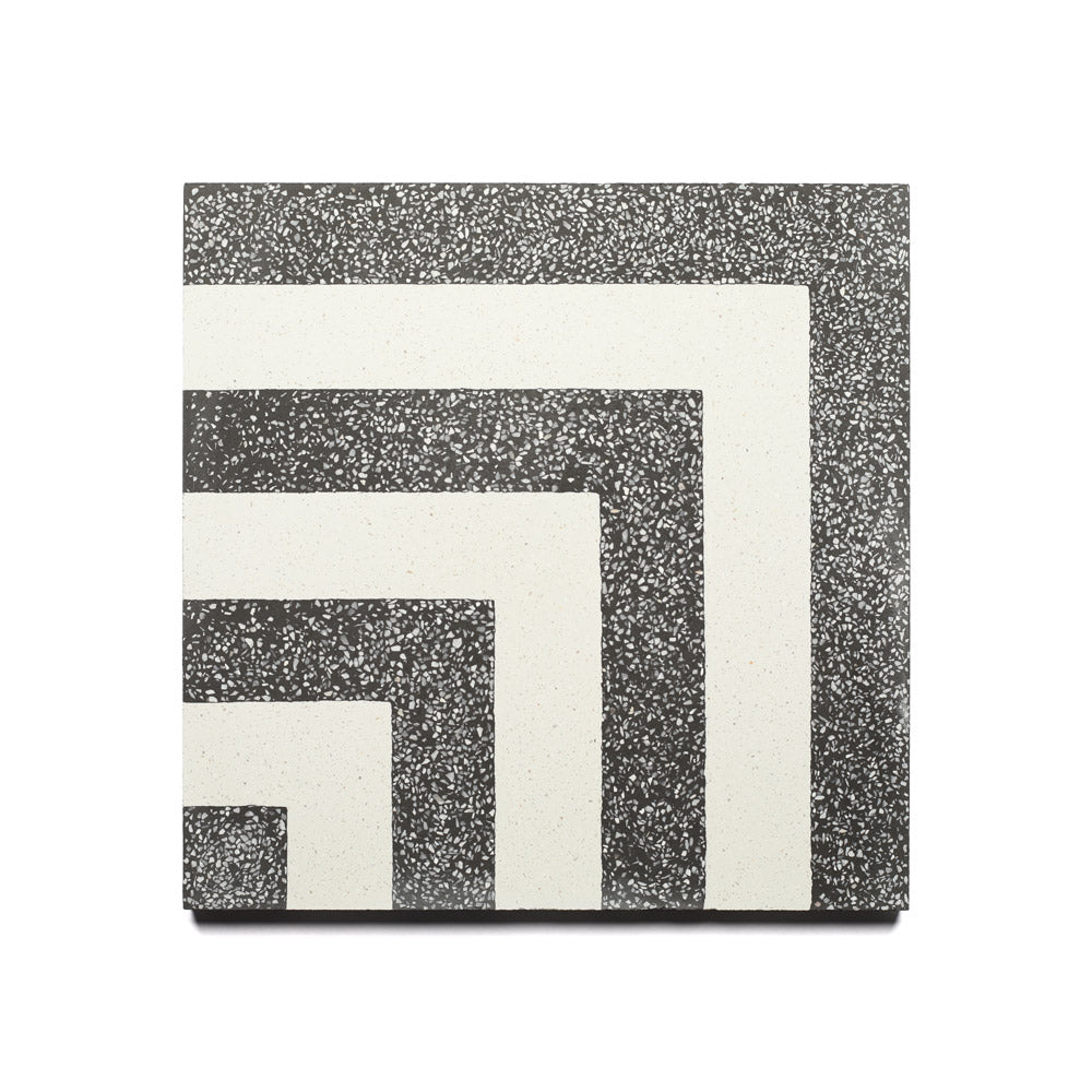 The Vesper Ash 12x12 sample from Zia Tile is a square handmade tile featuring a black and white speckled background with bold white right-angle lines in the corners, offering a modern, minimalist look inspired by classic Zia Tile cement styles.