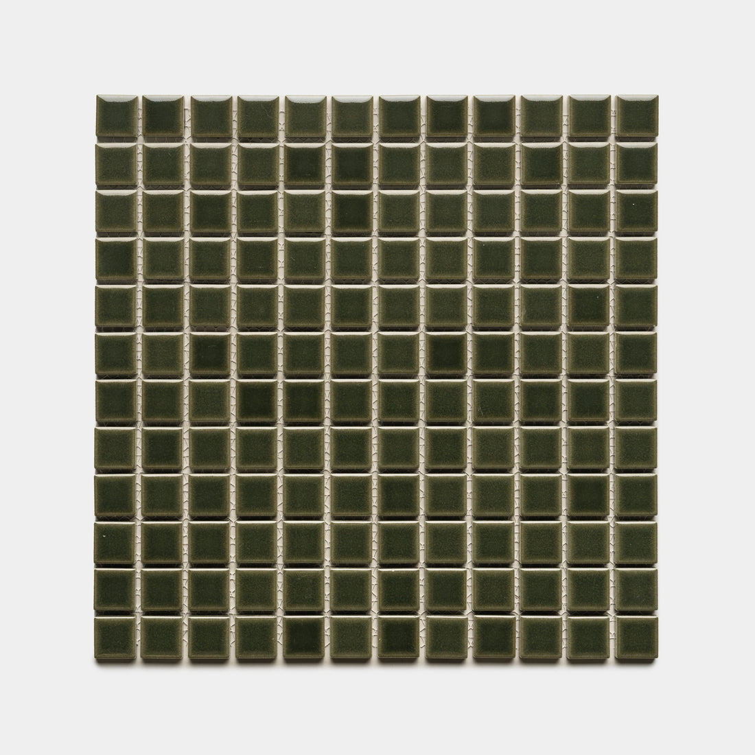 Zia Tile’s Vetiver 1x1 features small, dark green, glossy ceramic tiles in a square grid pattern, evenly arranged in rows and columns against a white background.