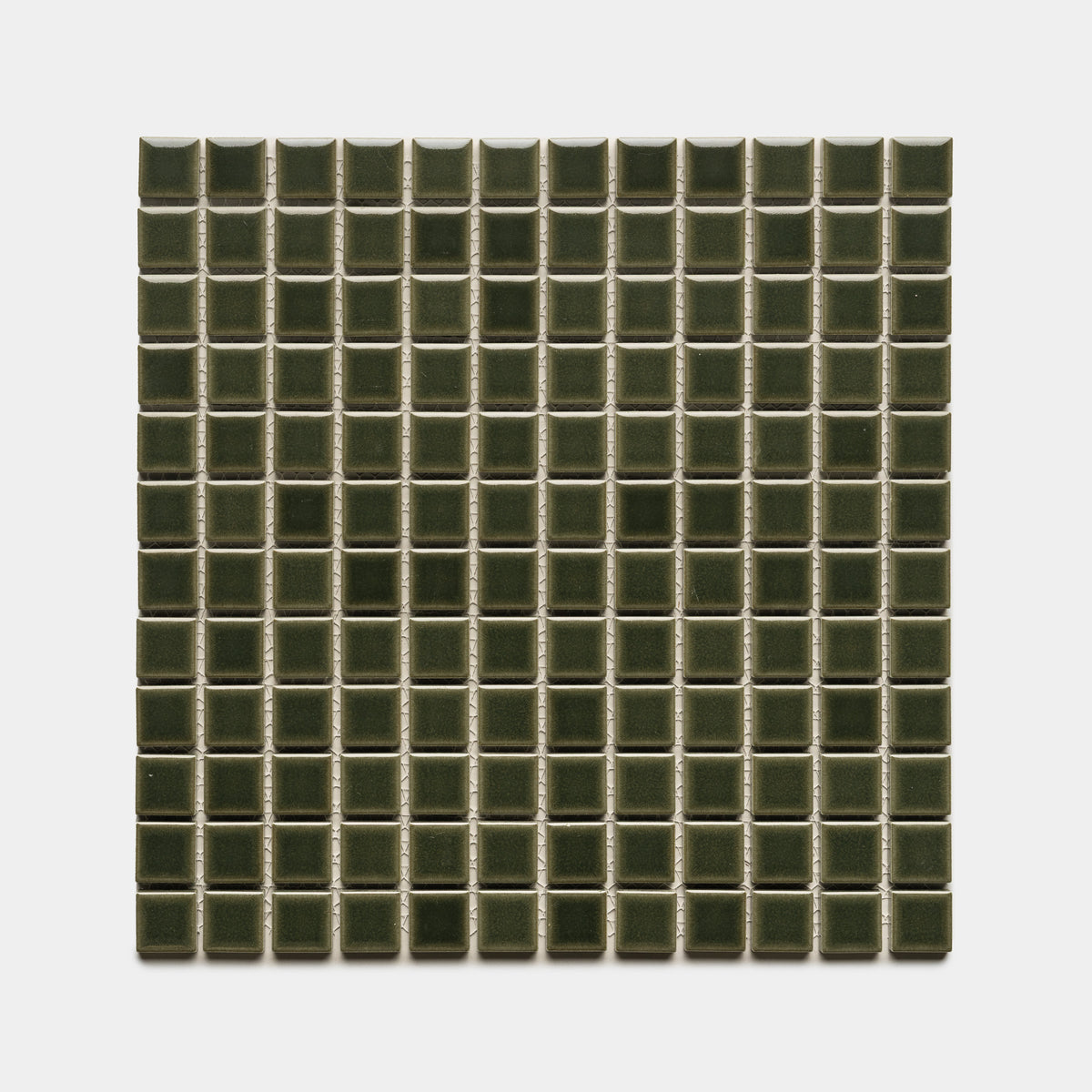Zia Tile’s Vetiver 1x1 features small, dark green, glossy ceramic tiles in a square grid pattern, evenly arranged in rows and columns against a white background.