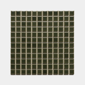 Zia Tile’s Vetiver 1x1 features small, dark green, glossy ceramic tiles in a square grid pattern, evenly arranged in rows and columns against a white background.