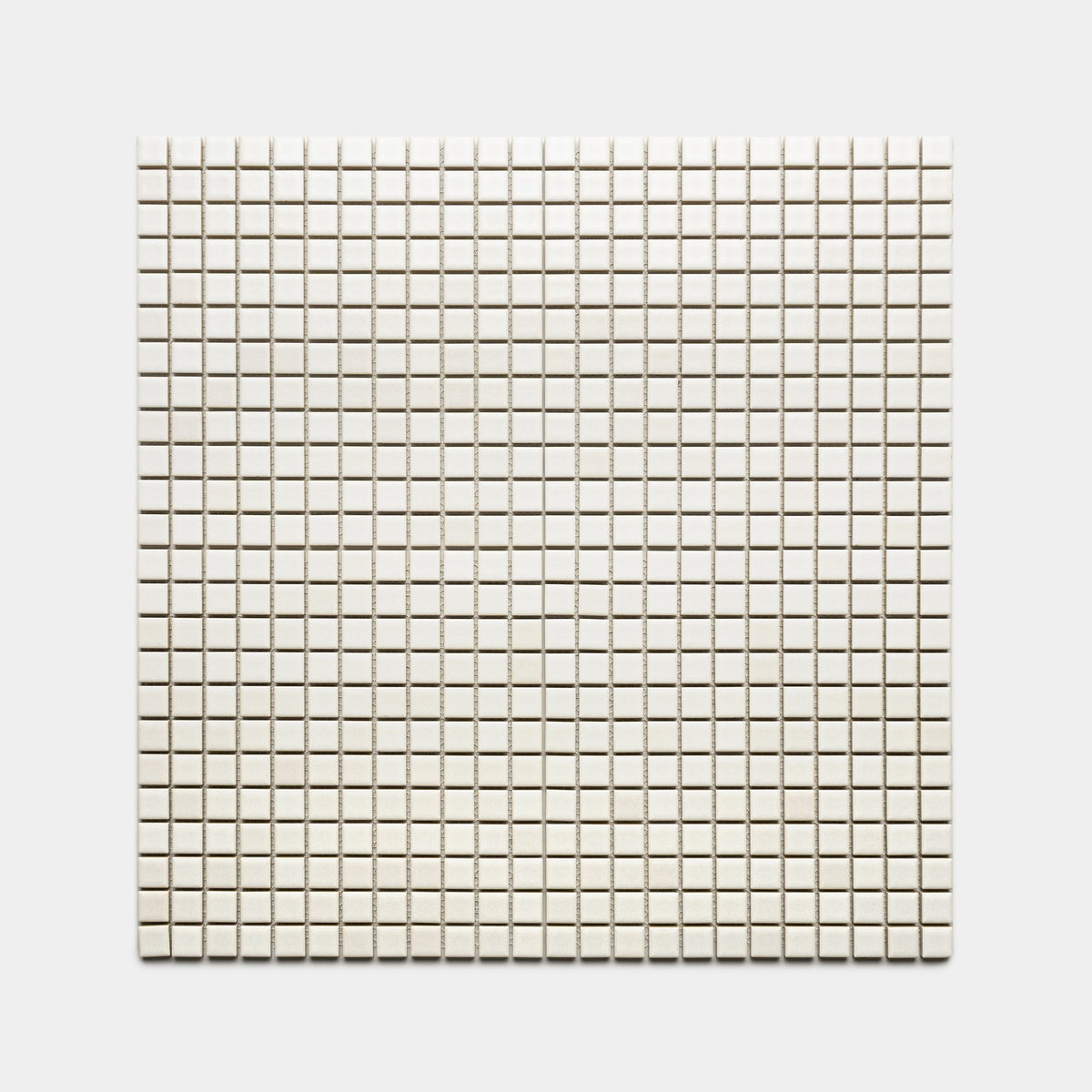 Wool 1x1 by Zia Tile features small, evenly spaced square white tiles arranged in a precise grid pattern against a light background.