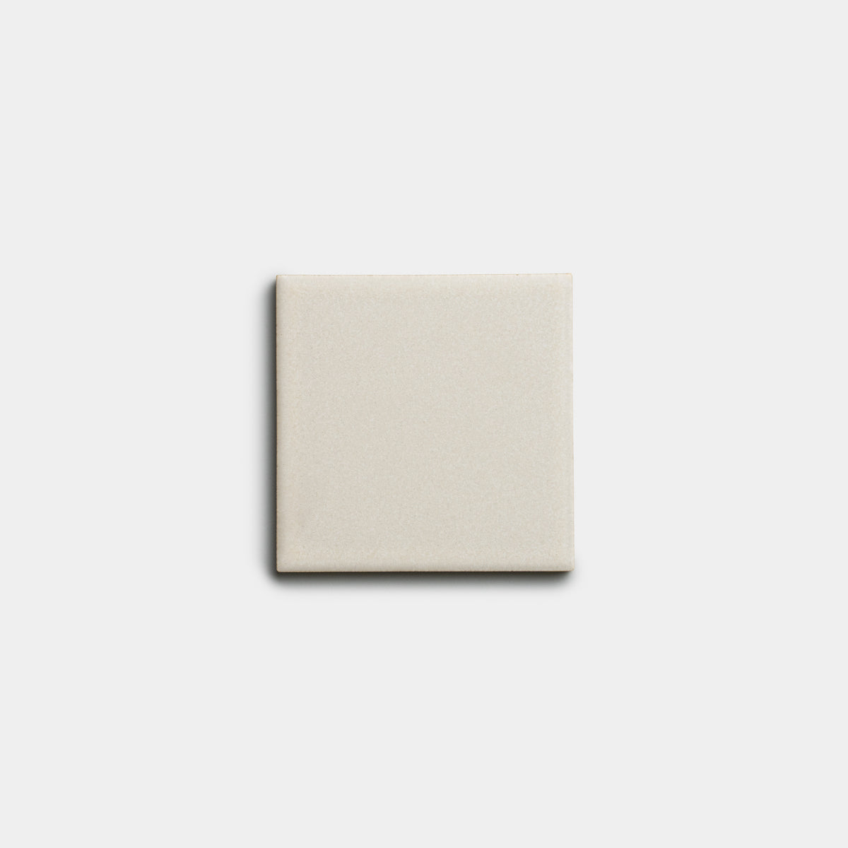 A single Wool 4x4 tile by Zia Tile, plain and light beige, is centered on a white background.