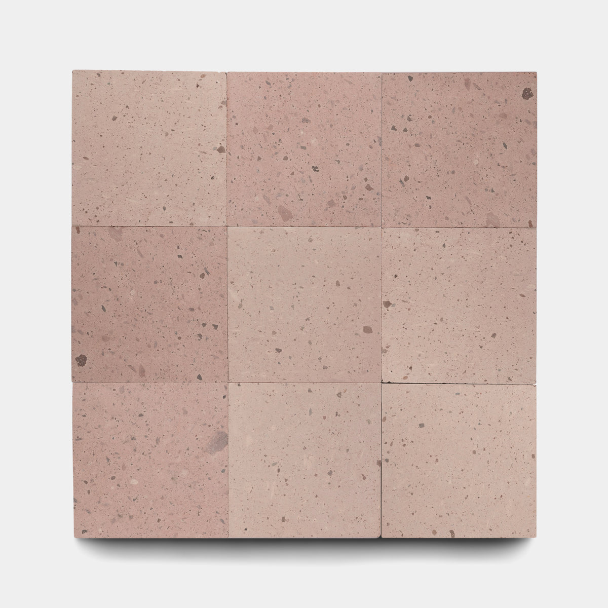 Nine Yuma 12x12 tiles by Zia Tile, featuring pinkish Cantera stone with a speckled, textured surface, are arranged in a 3x3 grid on a plain white background.