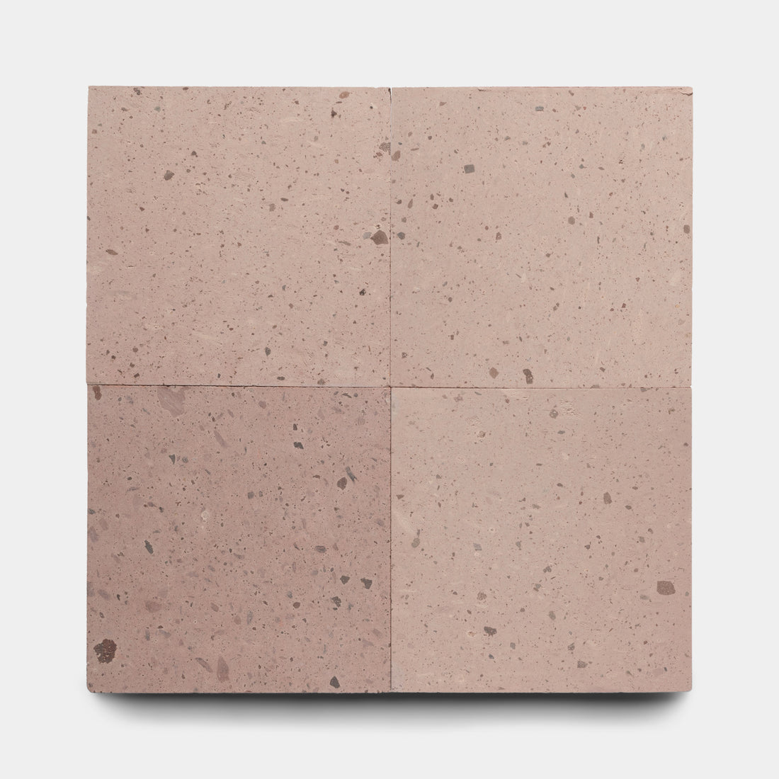 Four Yuma 24x24 square tiles by Zia Tile, featuring a pinkish-brown speckled, terrazzo-like texture, are arranged in a grid on a plain white background.