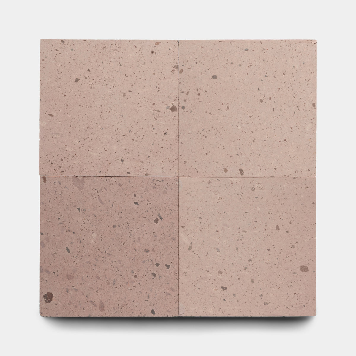 Four Yuma 24x24 square tiles by Zia Tile, featuring a pinkish-brown speckled, terrazzo-like texture, are arranged in a grid on a plain white background.