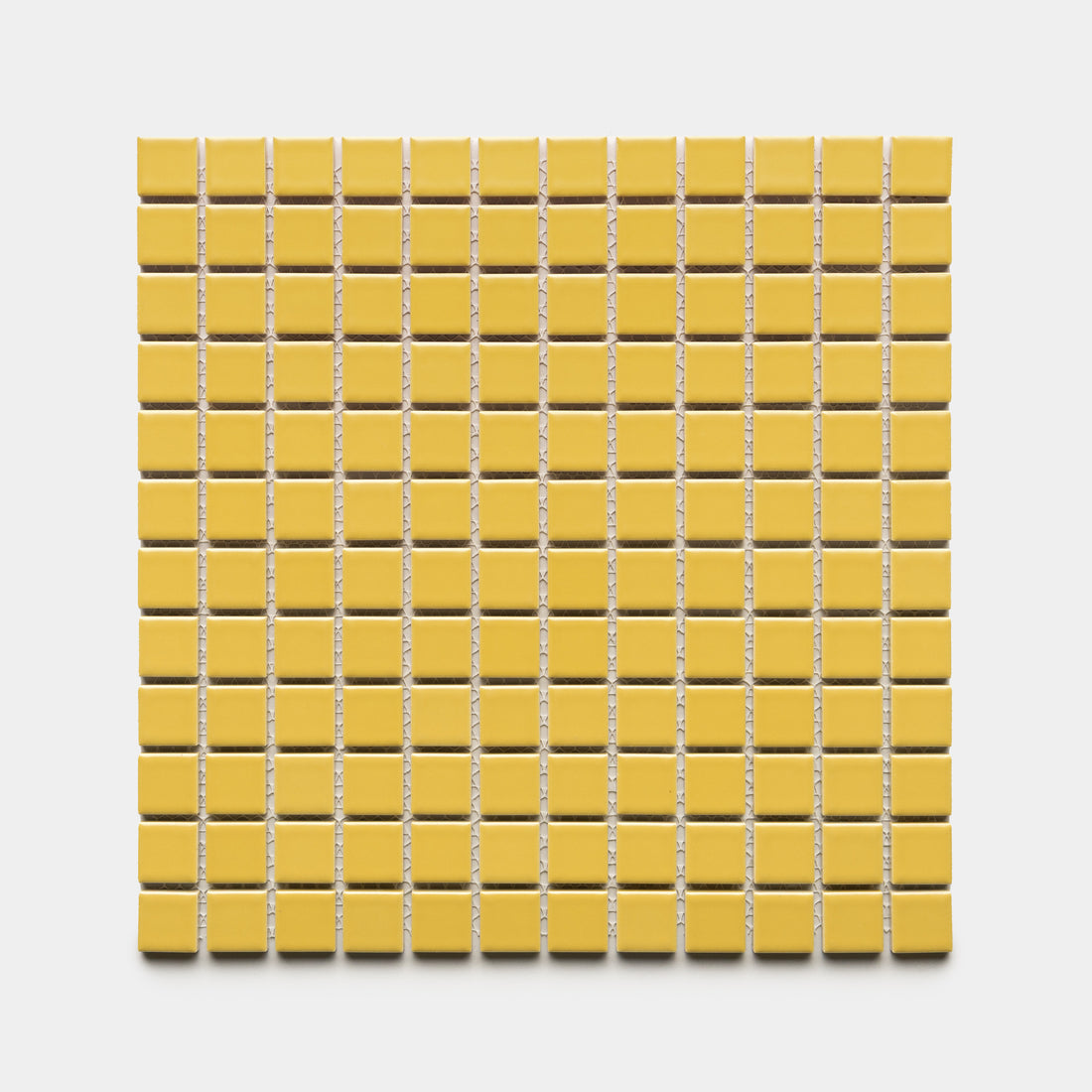 A square sheet of Zia Tile’s Yuzu 1x1 small yellow ceramic tiles is arranged in a grid against a white background.