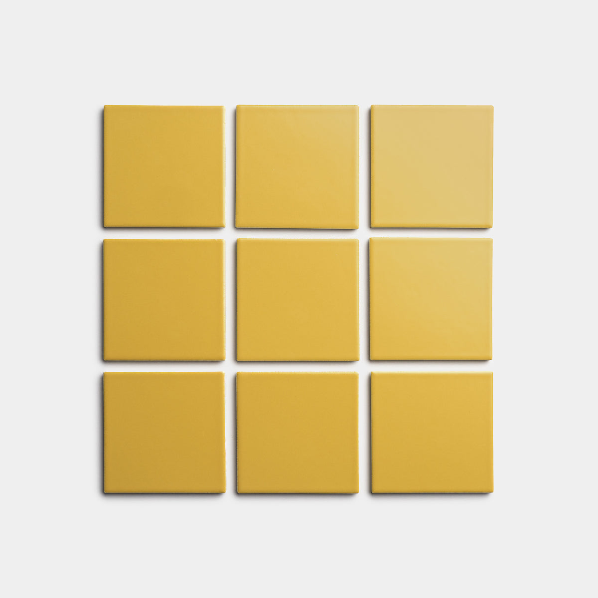 Nine Yuzu 4x4 yellow square tiles by Zia Tile are arranged in a 3x3 grid on a plain white background.