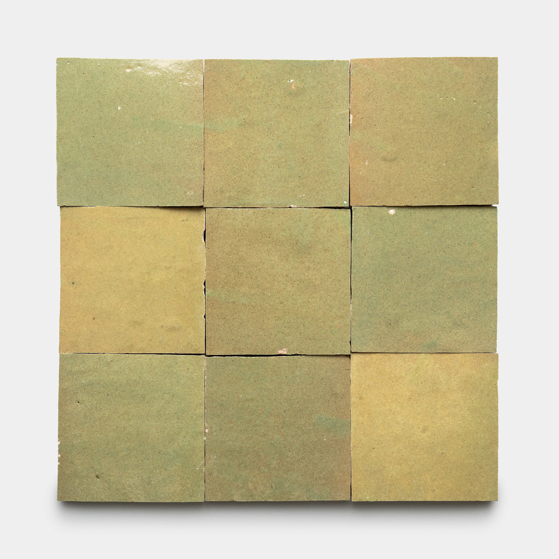 Nine Za'atar 4x4 tiles by Zia Tile, in a greenish-yellow shade with a matte finish, subtle color variations, and visible imperfections, are arranged in a 3x3 grid on a white background.