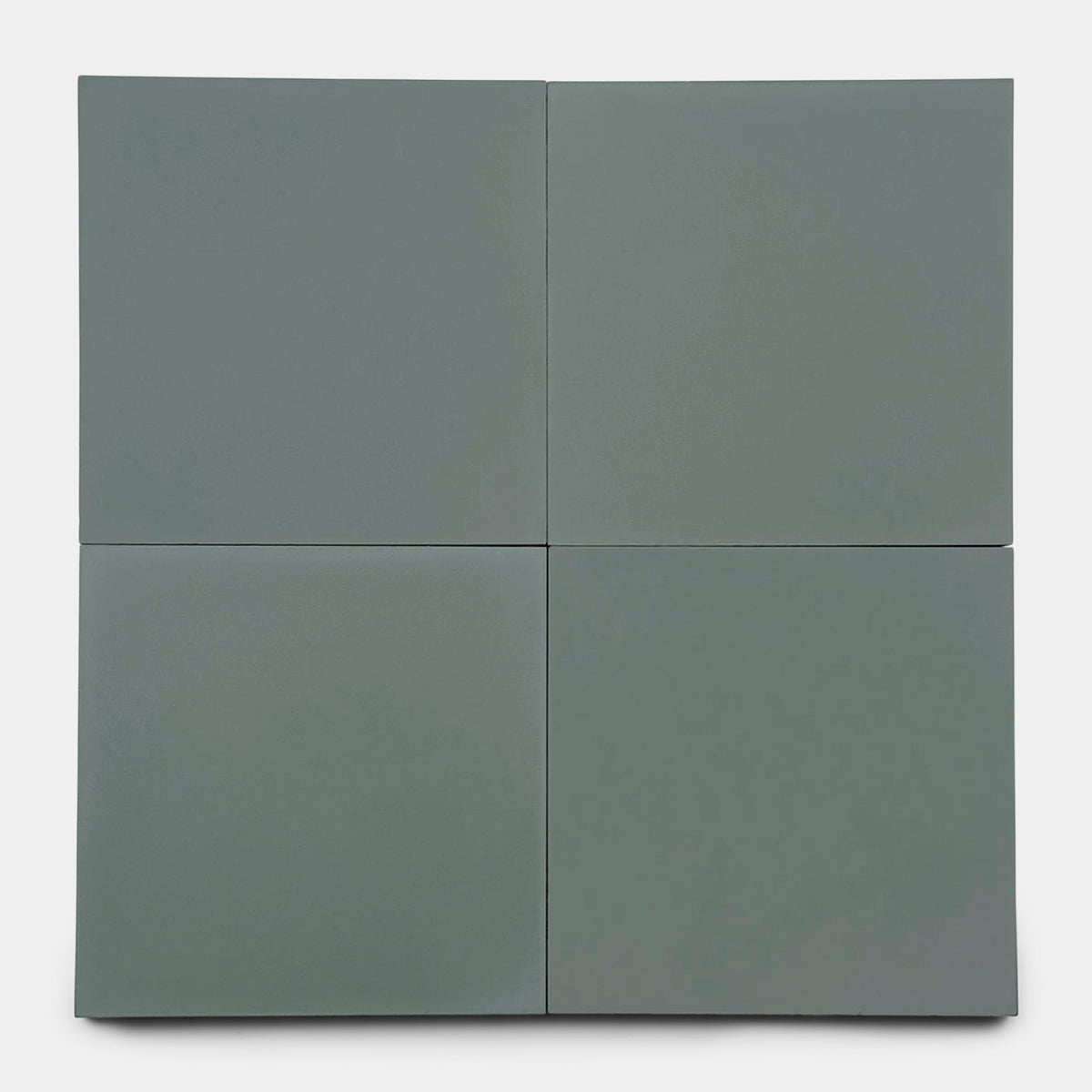 Four matte, square San Juan Zeppelin 8x8 cement tiles by Zia Tile are arranged in a 2x2 grid on a white background. Subtle edge shadows give each gray tile a slightly three-dimensional, artisanal look reminiscent of handmade craftsmanship.