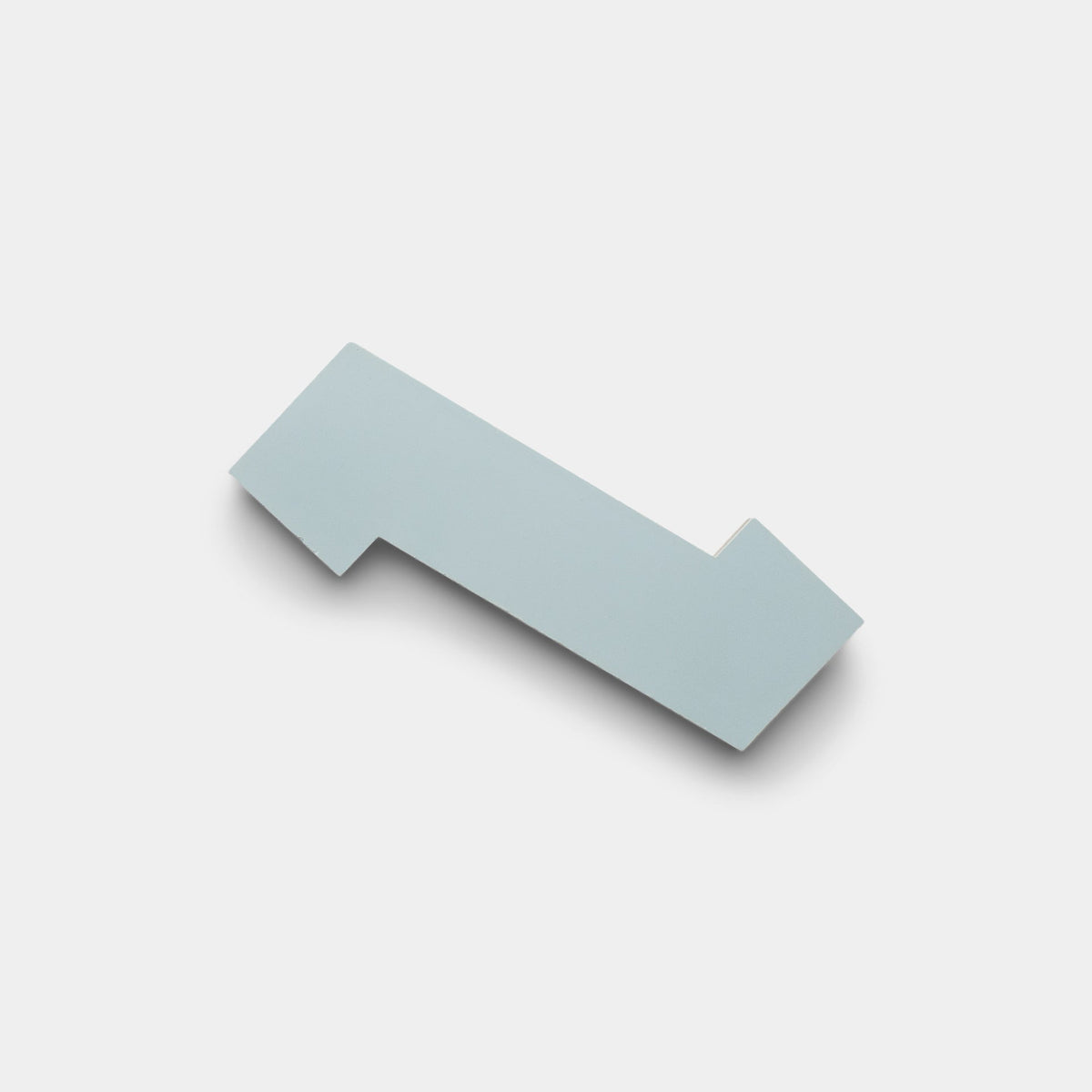 The Zig Zag Hailstone + Noble Green Sample by Zia Tile is a flat, geometric tile inspired by handmade design, shown in light blue on a plain light gray background with a soft shadow.