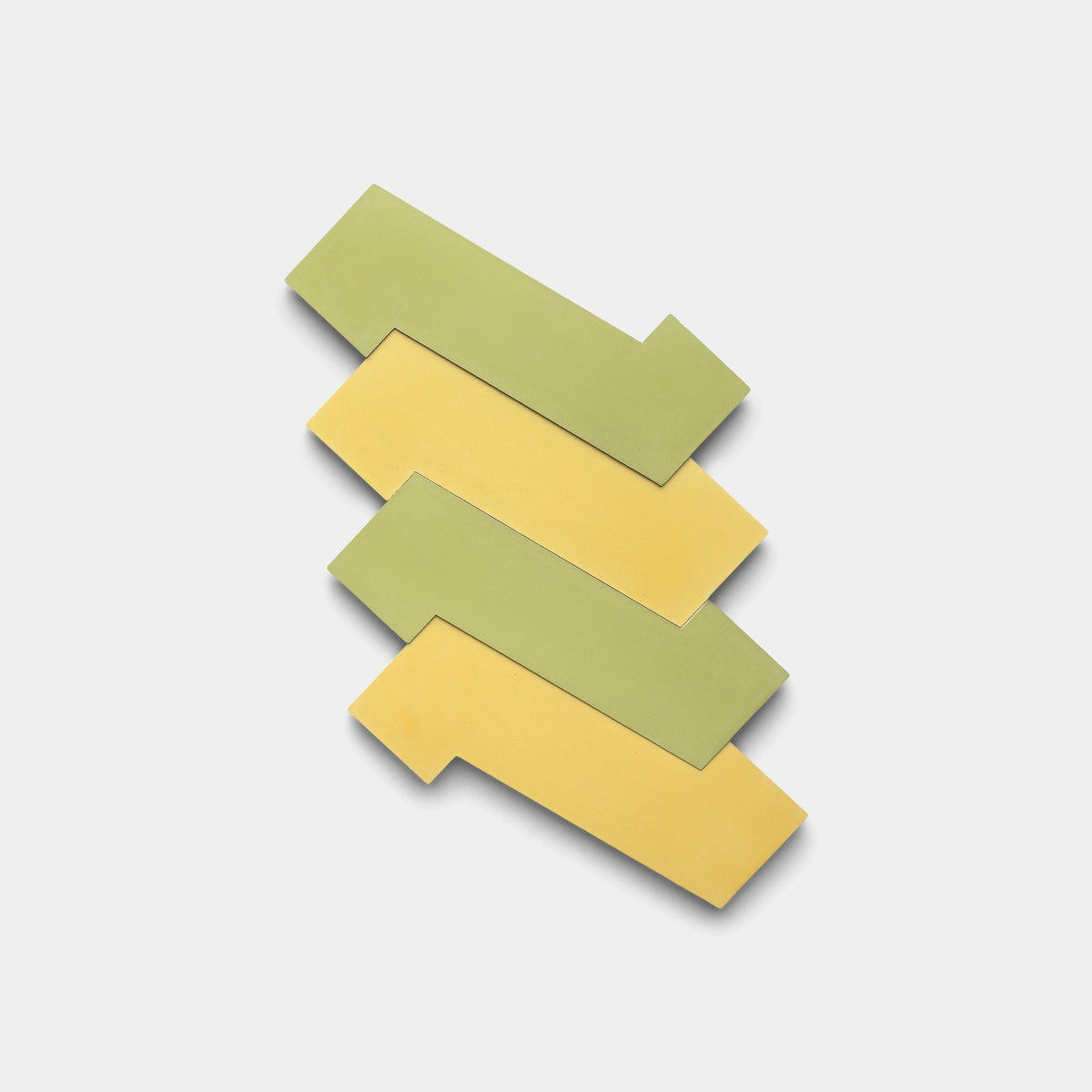 Four Zia Tile Zig Zag Lemongrass + Mustard sample tiles are arranged in a zigzag pattern on a plain white background.