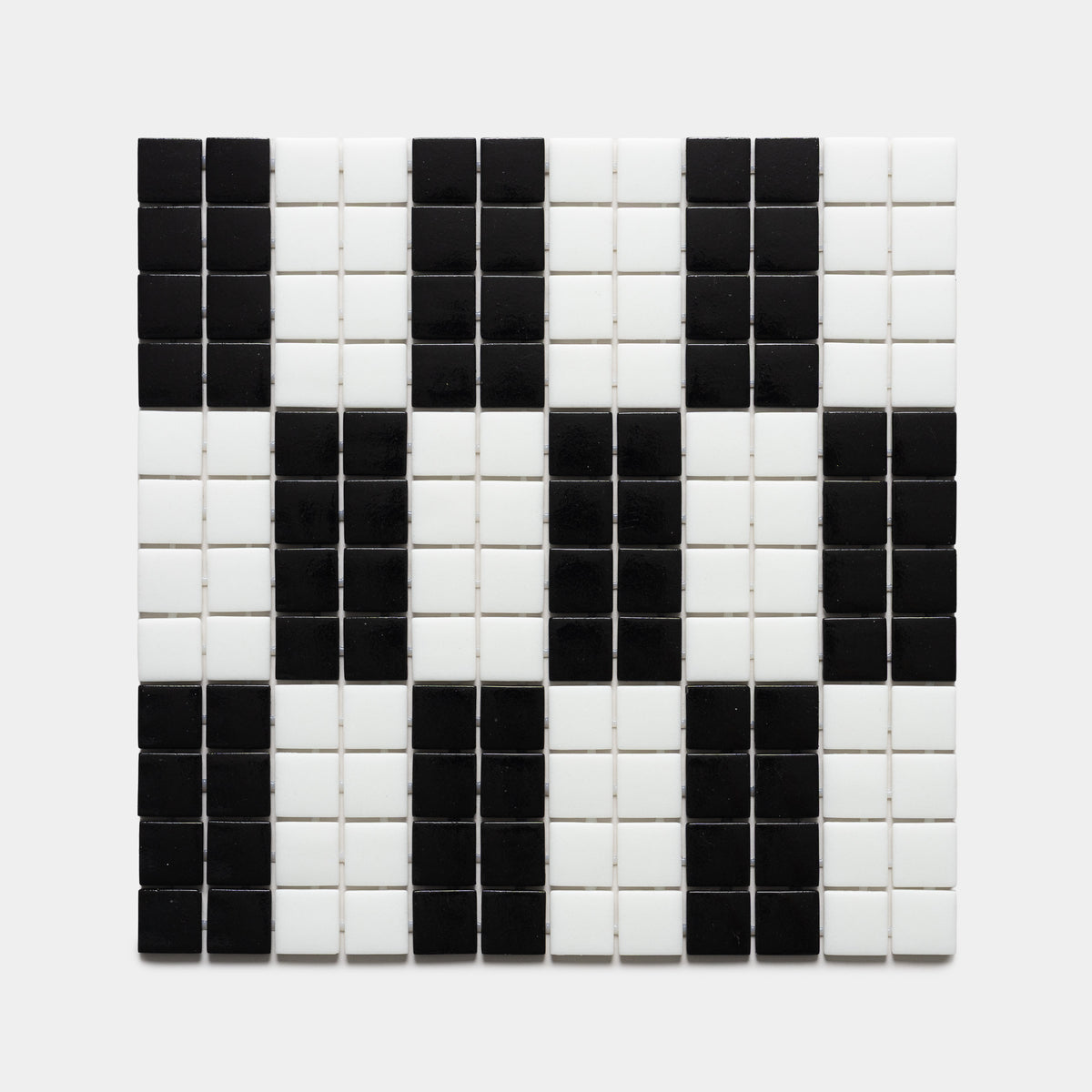 A square grid of d'Orsay Jet Black + Paperwhite tiles by Zia Tile forms a pixelated panda face on a plain light background.