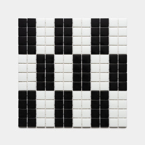 A square grid of d'Orsay Jet Black + Paperwhite tiles by Zia Tile forms a pixelated panda face on a plain light background.