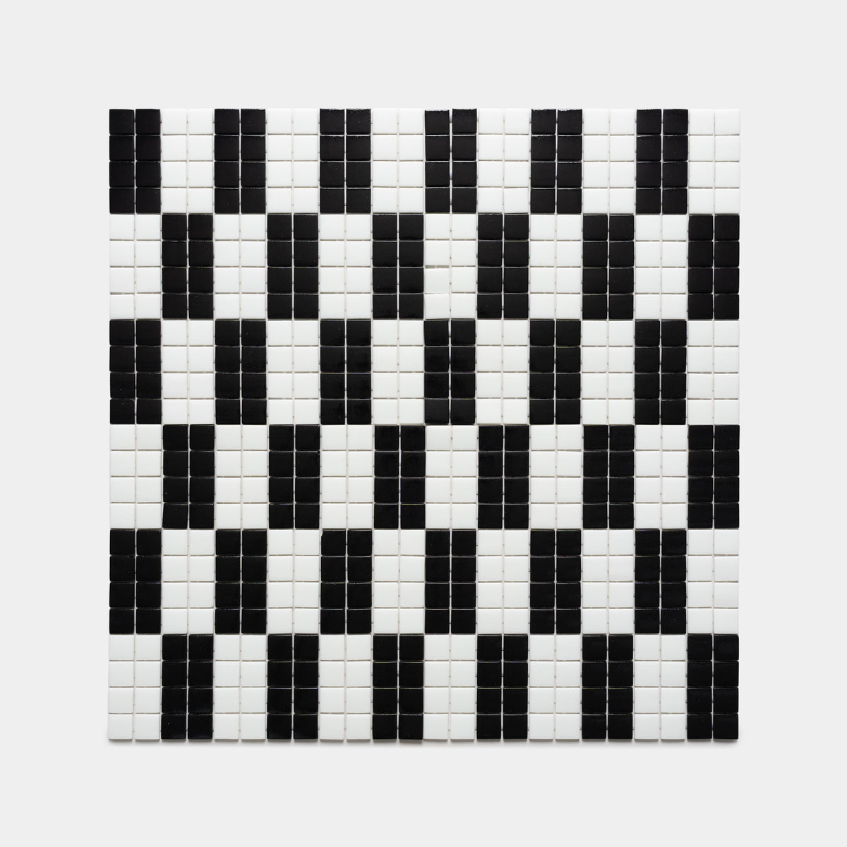 The d'Orsay Jet Black + Paperwhite tiles by Zia Tile feature a grid of small white tiles with black rectangular patterns in rows, producing a striking, geometric optical illusion.