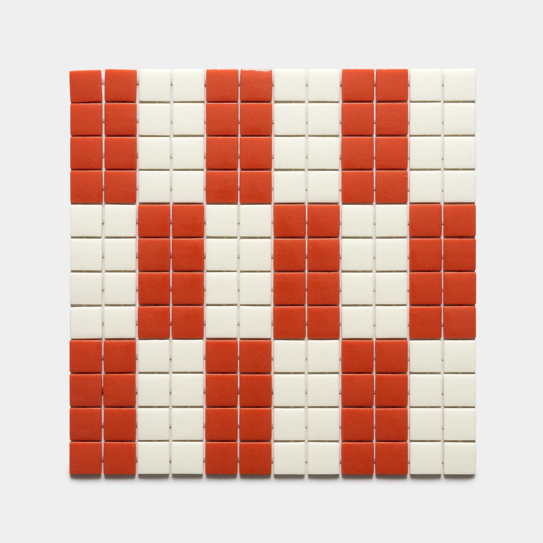 A grid of Zia Tile's d'Orsay Roma + Milk, Sample tiles displays red and white squares in a checkered diamond pattern on a light background.