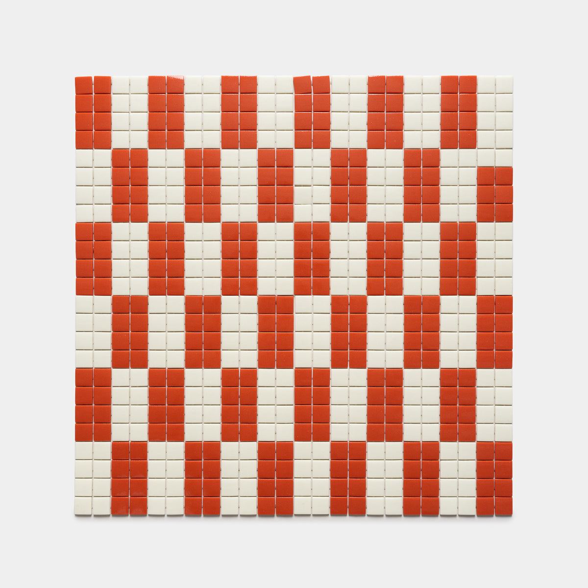The d'Orsay Roma + Milk by Zia Tile features a grid of small square tiles in a red and white checkerboard pattern, creating a bold geometric design on a white background.