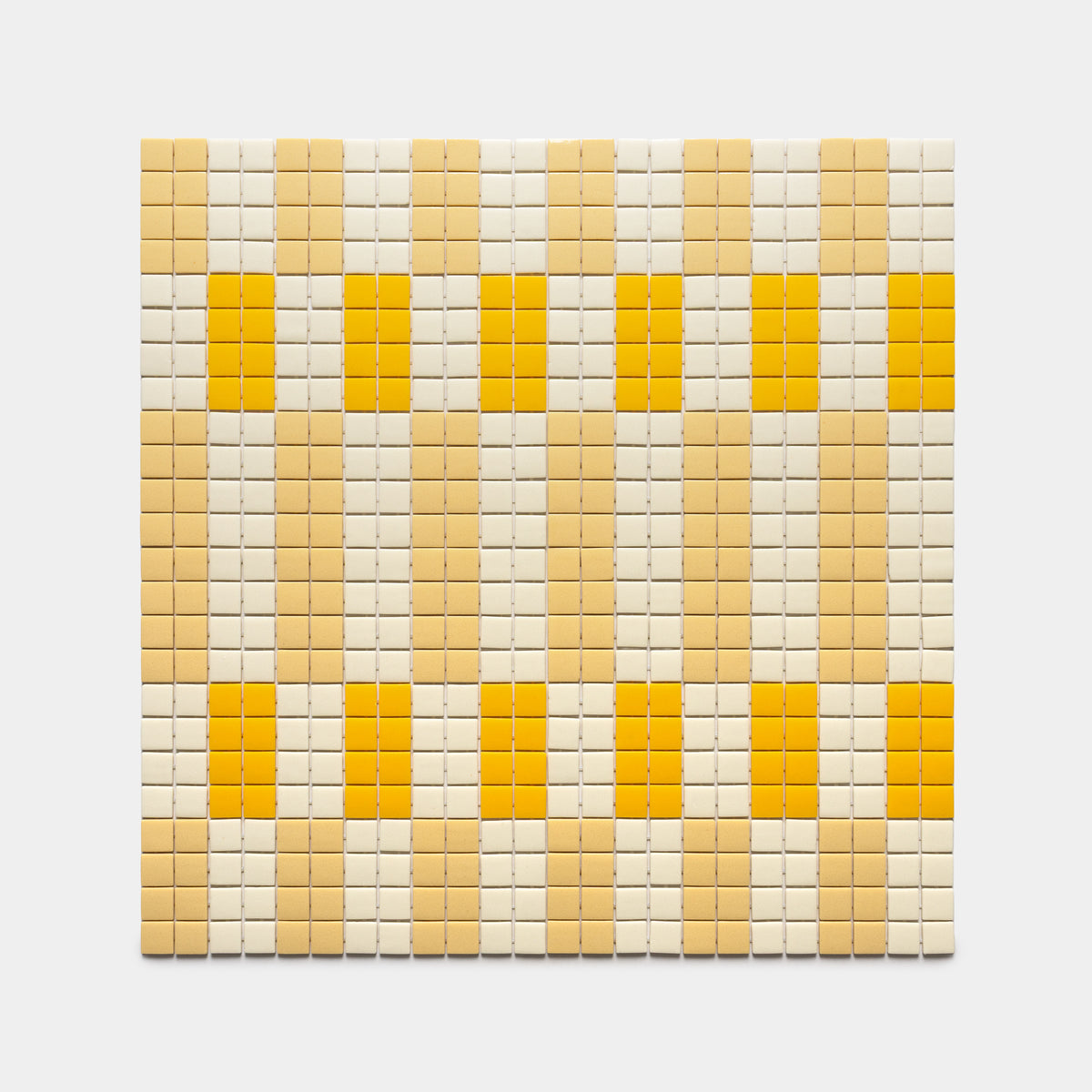 The d'Orsay Buttercup + Sesame + Canary by Zia Tile is a square mosaic panel with small yellow, beige, and cream tiles in a geometric grid pattern on a plain light gray background.