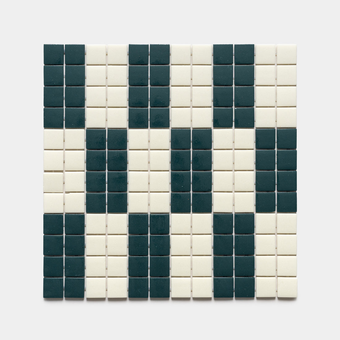 The d'Orsay Vespertine + Milk sample by Zia Tile features a rectangular grid of small square tiles in black and white, forming an abstract, pixelated face or skull pattern on a white background.