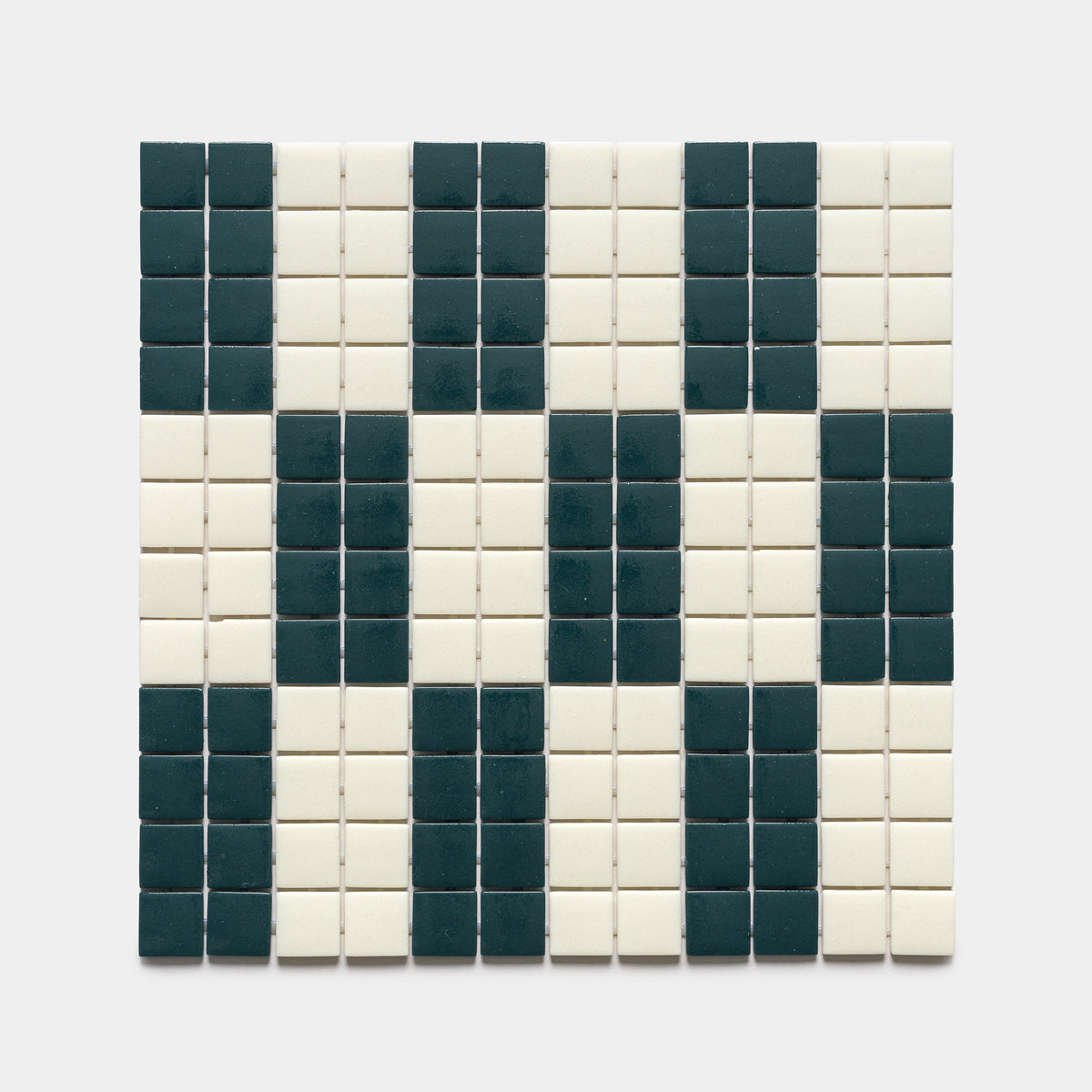 The d'Orsay Vespertine + Milk sample by Zia Tile features a rectangular grid of small square tiles in black and white, forming an abstract, pixelated face or skull pattern on a white background.
