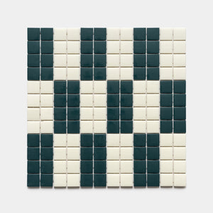 The d'Orsay Vespertine + Milk sample by Zia Tile features a rectangular grid of small square tiles in black and white, forming an abstract, pixelated face or skull pattern on a white background.