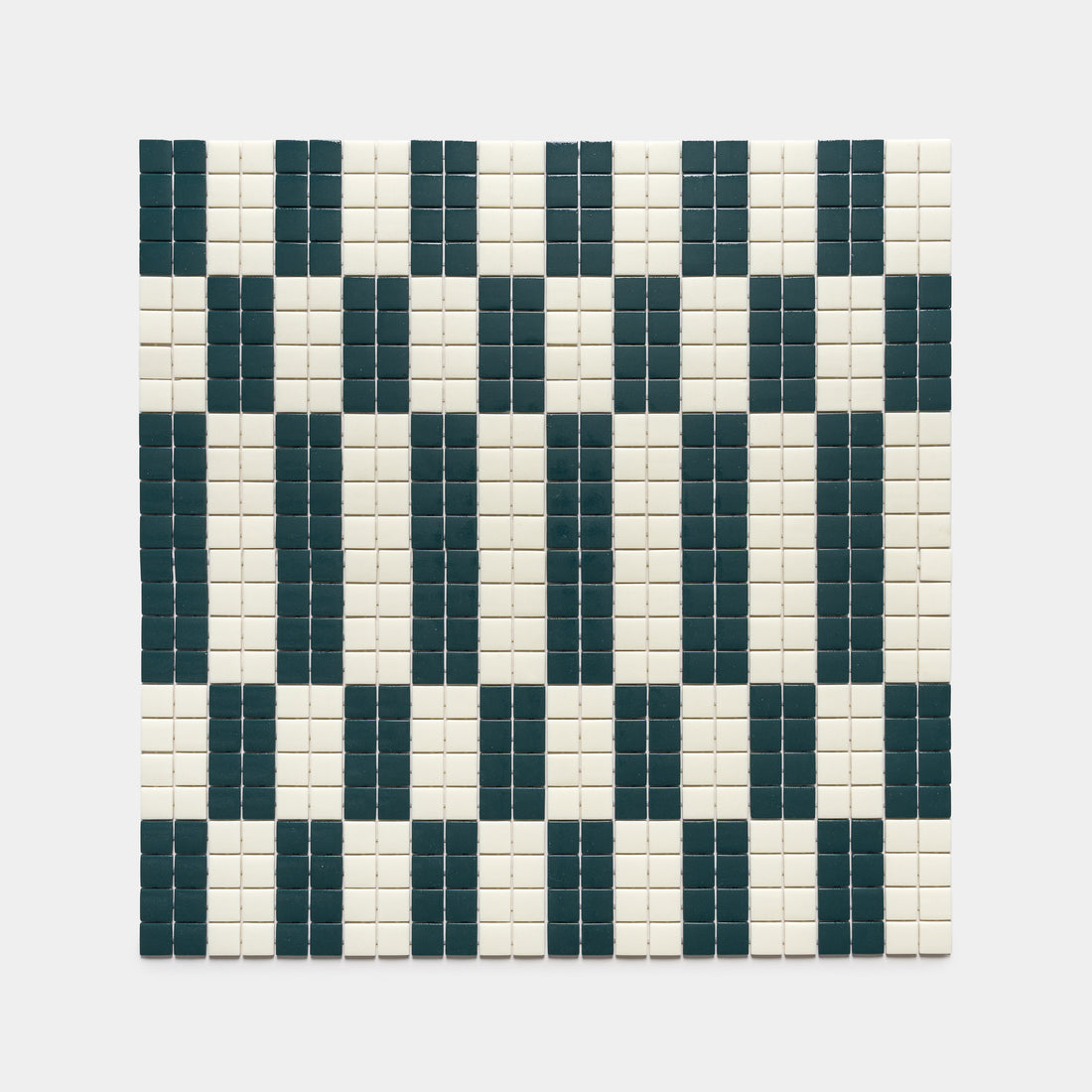The d'Orsay Vespertine + Milk by Zia Tile features a square grid of small tiles in a geometric pattern, with alternating vertical columns of dark green and white on a light background for a rhythmic, barcode-like effect.