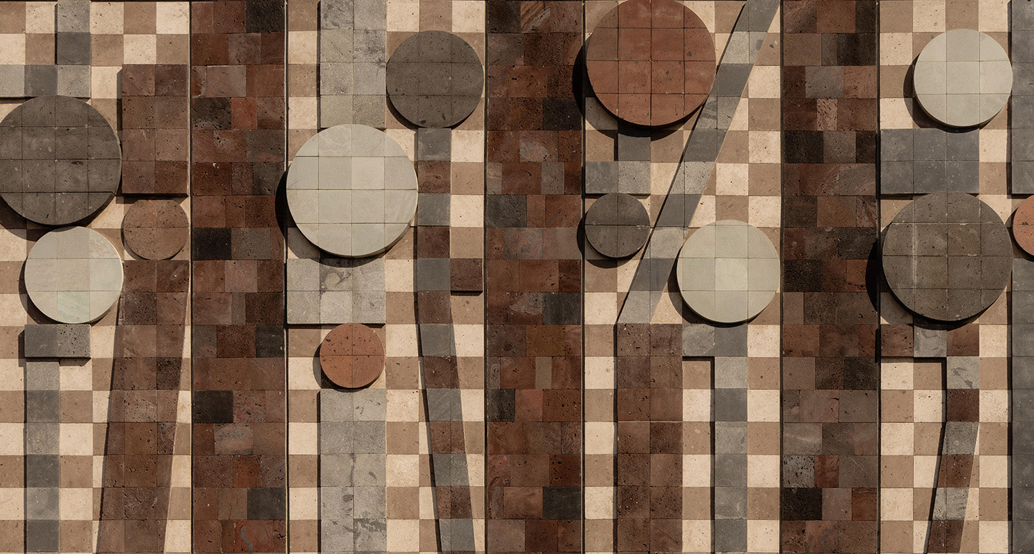 A tiled wall features a geometric pattern of brown, beige, and gray squares with several large and small circular and rectangular shapes in various neutral tones overlapping the checkered background.